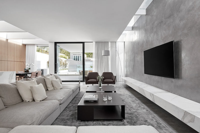 In this living area, a material palette of stone, concrete and metal has been used to create a cool contemporary look and feel.