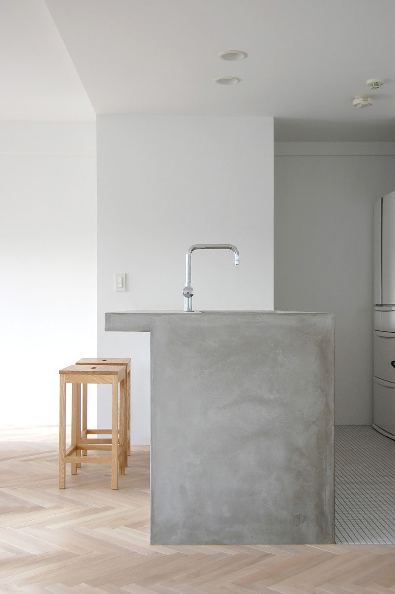 16 Inspirational Pictures Of Herringbone Floors // This kitchen combines a light herringbone floor and an all concrete island for a natural look.