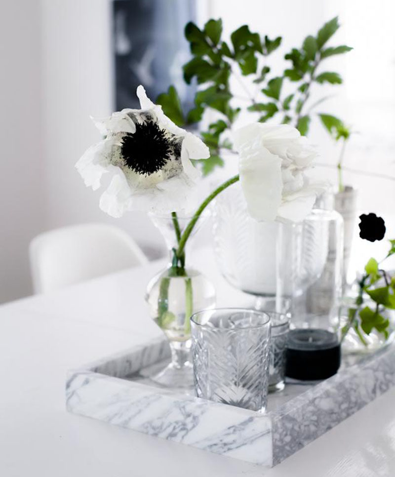 Home Decor Ideas - 6 Ways To Use Serving Trays In Your Decor // In the dining room, decorated with glassware and flowers.