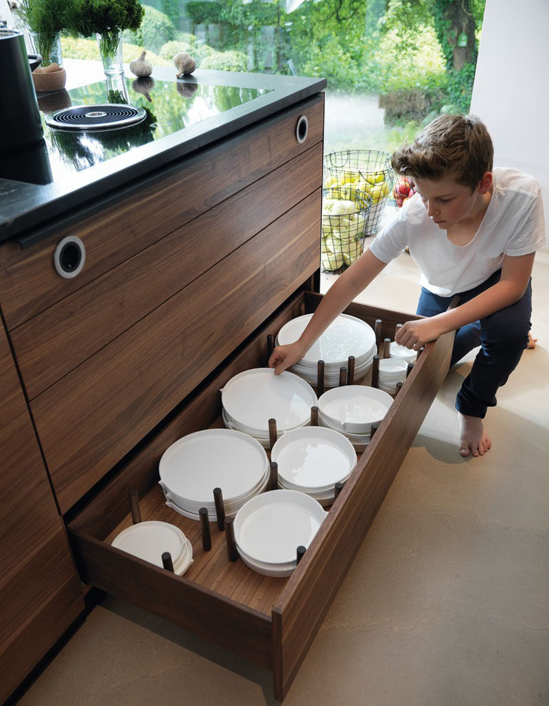 Kitchen Drawer Organization - Design Your Drawers So Everything Has A Place // Cylindrical wood dowels create individual sections for the plates to sit in to maximize storage space and to protect the dishes.