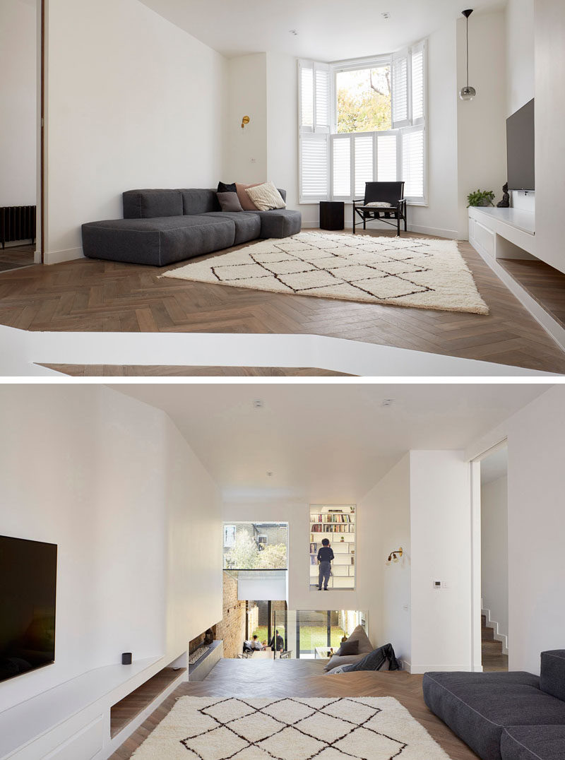 This living room in a renovated home has views of the dining area and backyard.