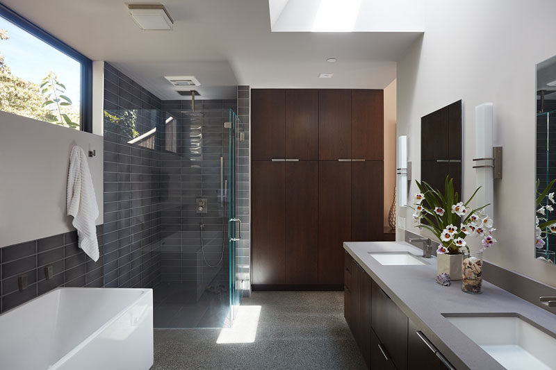 In this master bathroom, there's plenty of light from the window and skylight, and the shower has been separated from the bath, although they do share the same gray subway tile.