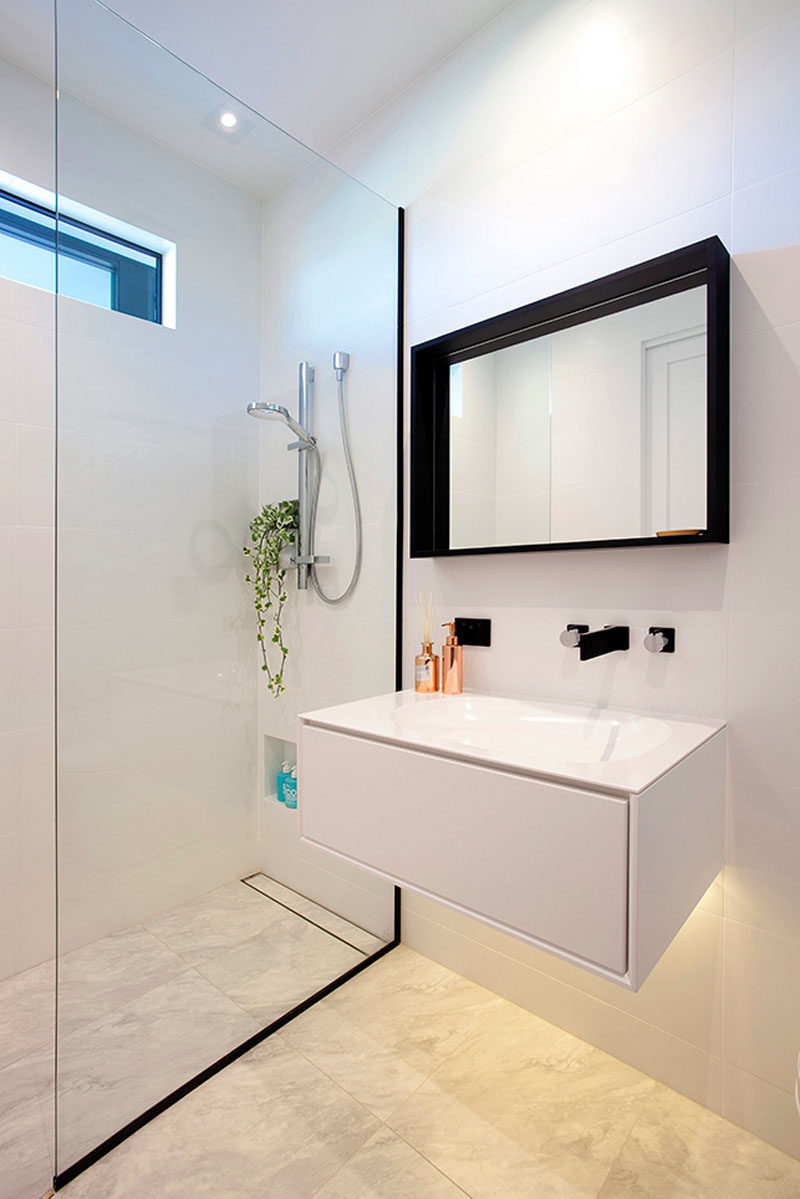 This bathroom has a vanity with hidden lighting underneath to keep the bathroom looking bright.