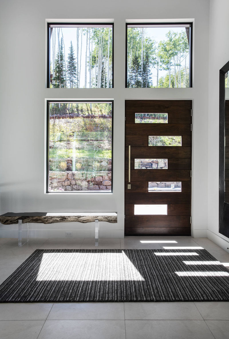 Entryway Design Ideas - 3 Different Styles Of Entryway Benches // This bright entryway is made to feel a little cozier with the help of this raw edge wood bench.