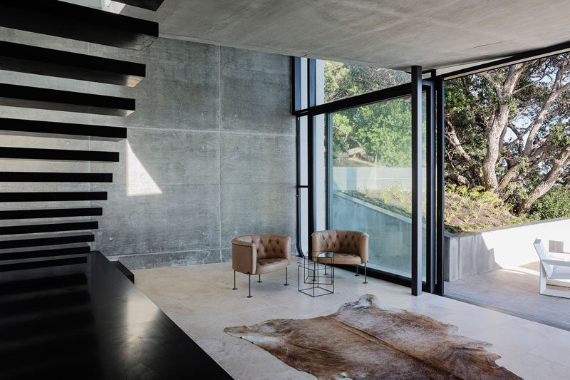 Bare concrete walls have been paired with Travertine flooring to create a cool, contemporary look in this New Zealand home.