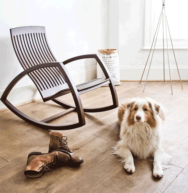 The open sides and floating seat of this rocking chair give it a more modern feel white the dark wood makes it warm and inviting. #ModernRockingChair #RockingChair #SeatingDesign #FurnitureDesign