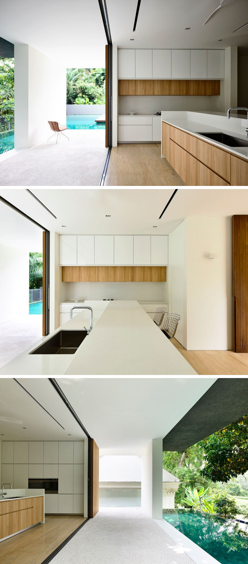 The entire length of this white and wood kitchen is open to the swimming pool.