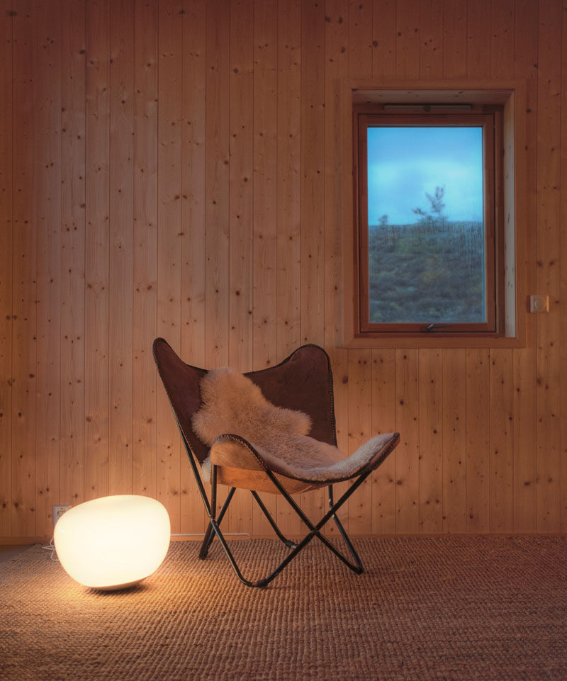 Simple wood walls have been used throughout this Norwegian cabin to tie in with the nature outside.