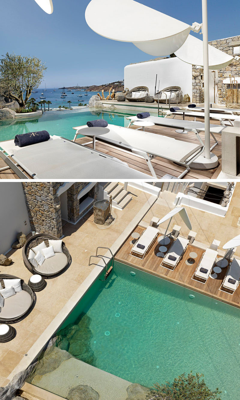 Sun lounges surround the hotel pool that incorporates the natural rock, and also has sea views.