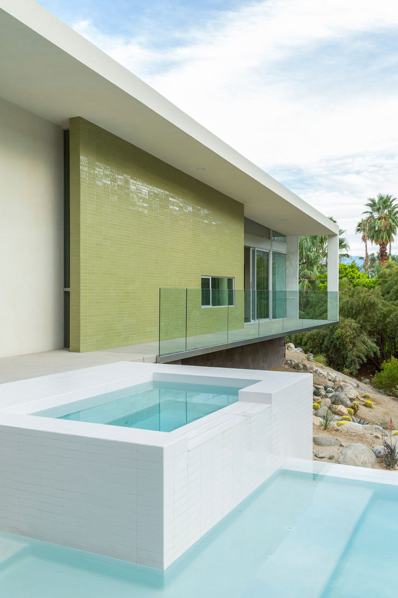 Green tile has been used on the exterior of the master wing in this house.