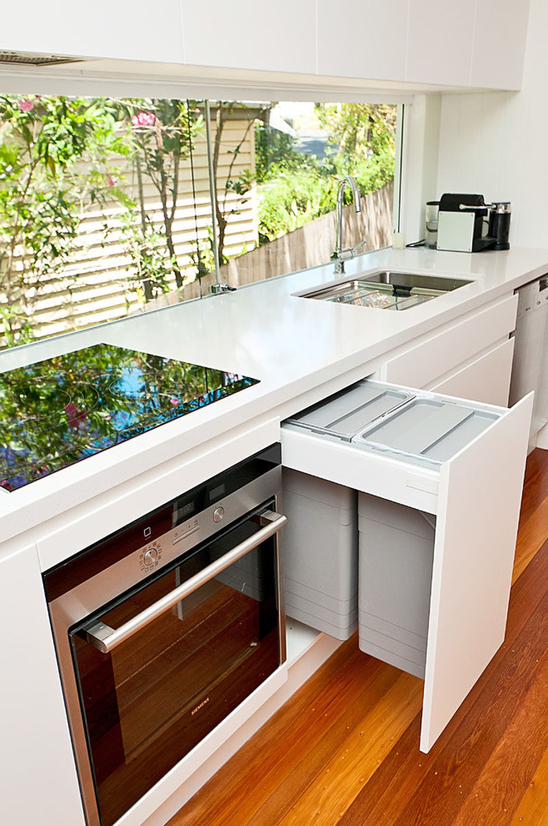 Kitchen Design Idea - Hide Pull Out Trash Bins In Your Cabinetry // These trash bins hang from the top of the drawer making them slightly closer to you and even more convenient to use.