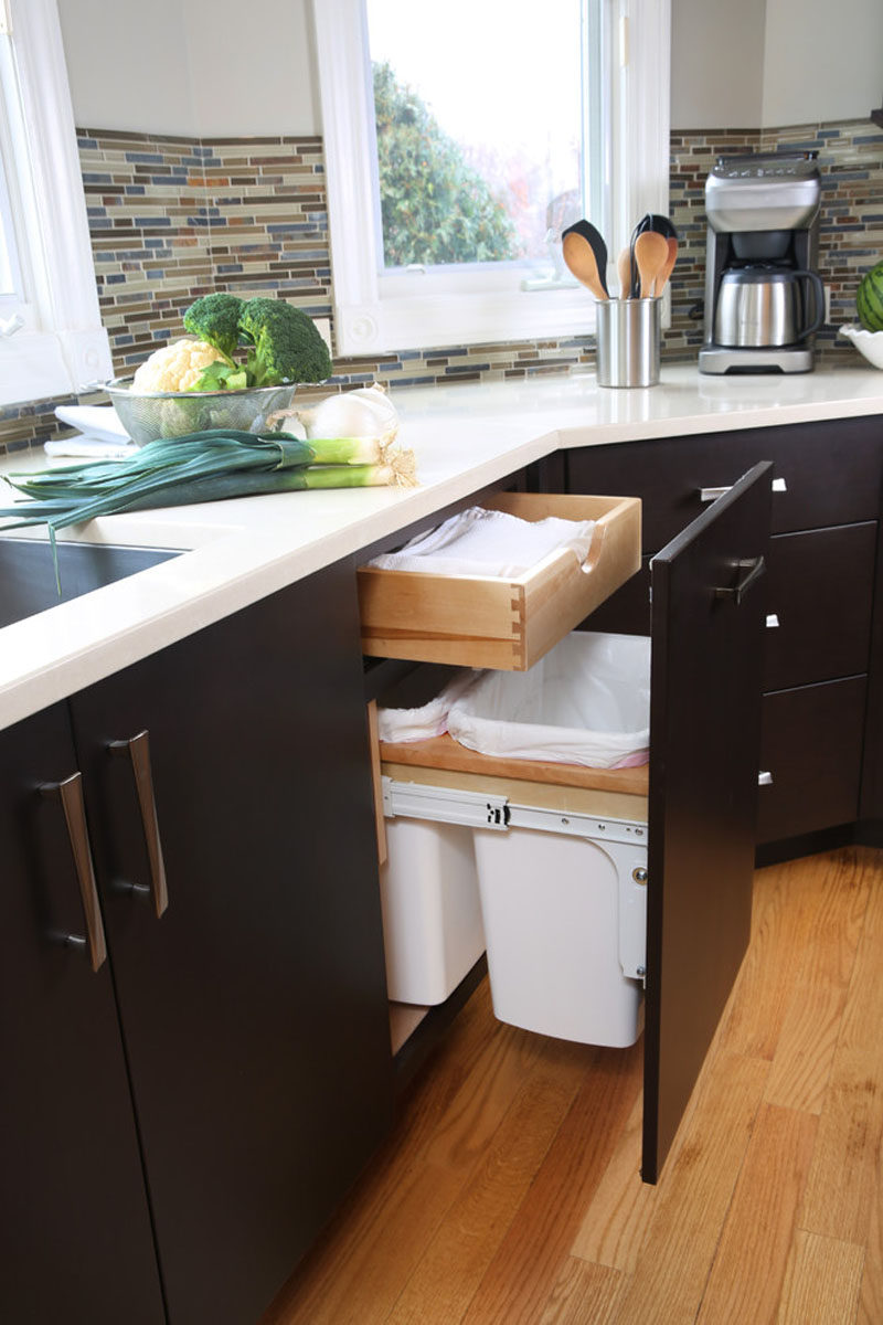 Kitchen Design Idea - Hide Pull Out Trash Bins In Your Cabinetry // The pull out trash bins in this kitchen also hang but are lower down to accommodate a drawer that sits above them.