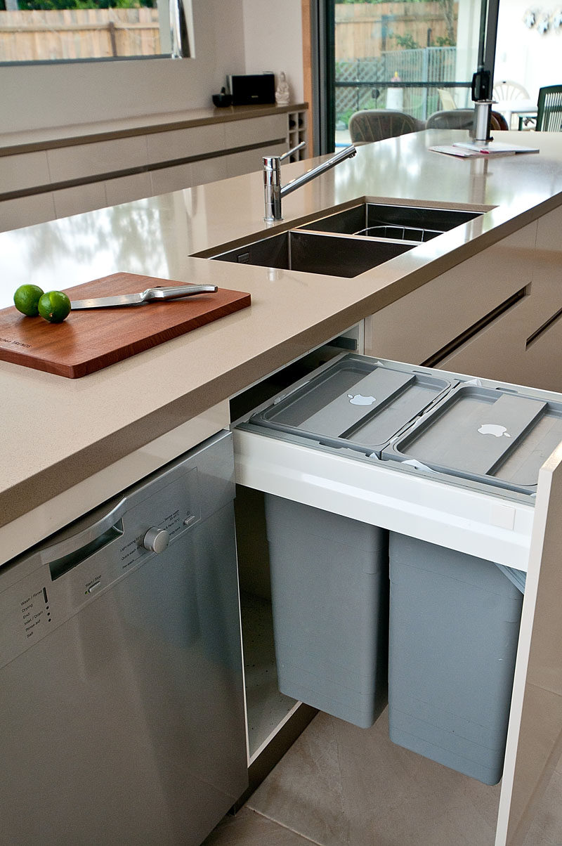 Kitchen Design Idea - Hide Pull Out Trash Bins In Your Cabinetry // Having the pull out trash bins right next to the sink and dishwasher makes it easy to scrape left over food into the garbage then load them into the dishwasher.