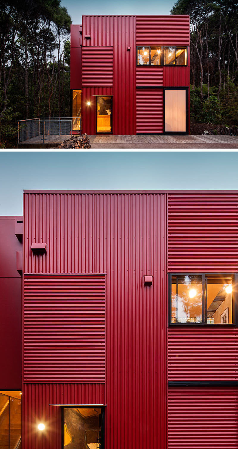 11 Red Houses And Buildings That Aren't Afraid To Make A Statement // Red corrugated metal siding makes this house in the trees pop against the greenery of the forest.