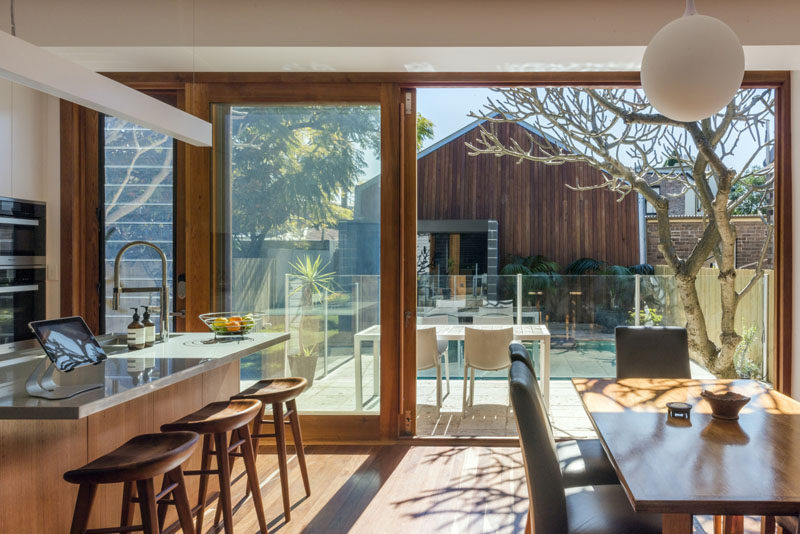 This combined kitchen and dining room open up to a balcony that overlooks the backyard.