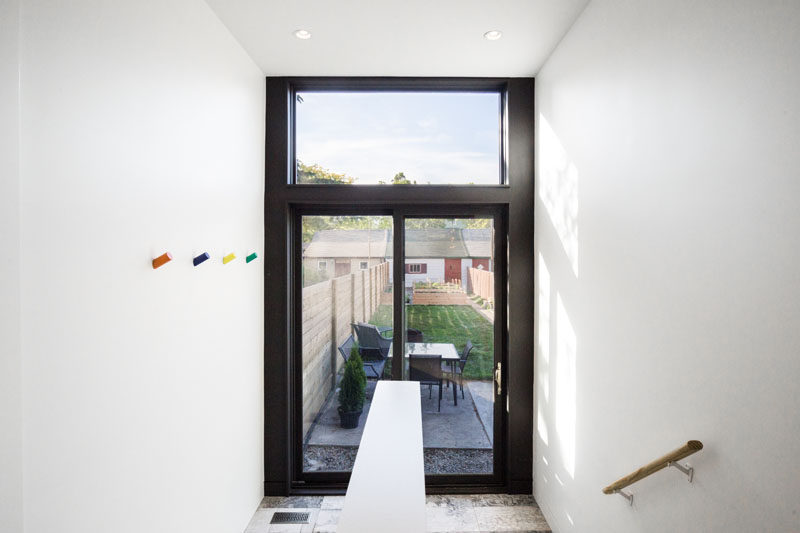 A black-framed sliding glass door provides access to the backyard and small patio in this renovated home.