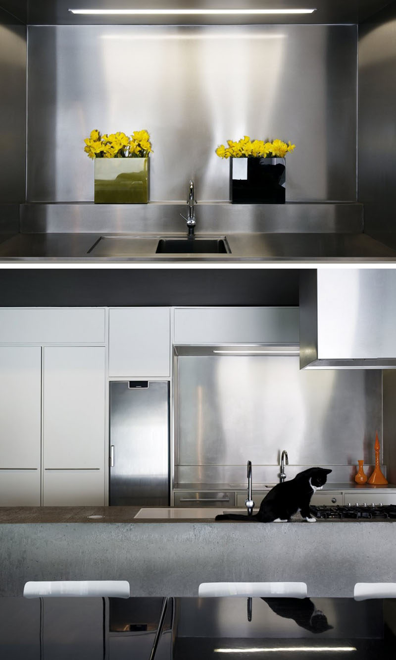 Kitchen Design Idea - Stainless Steel Backsplash // The combination of the stainless steel backsplash and the concrete island make for a durable, contemporary kitchen.