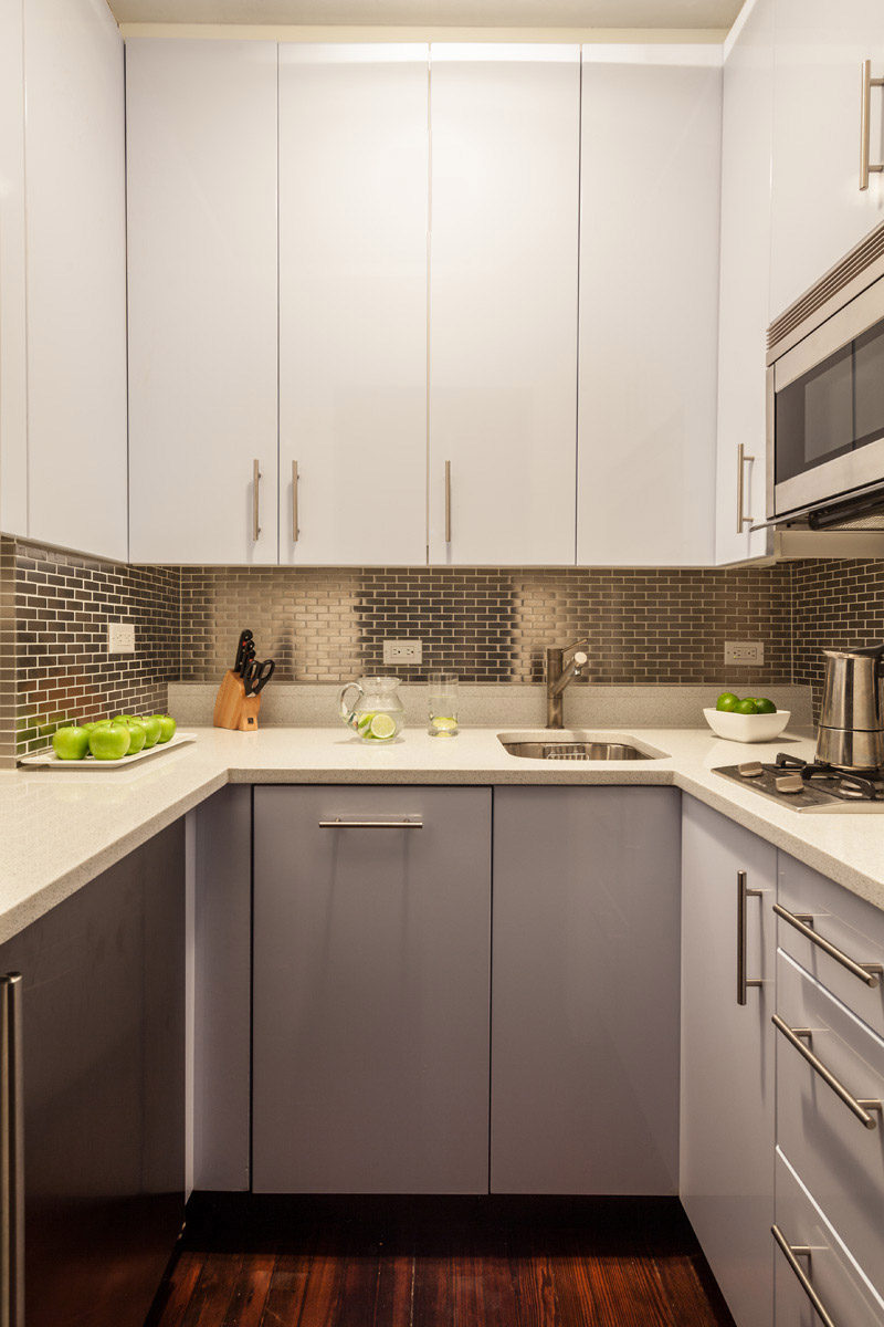 Kitchen Design Idea - Stainless Steel Backsplash // The brick-like arrangement of these stainless steel tiles adds texture and brightness to this tiny kitchen.