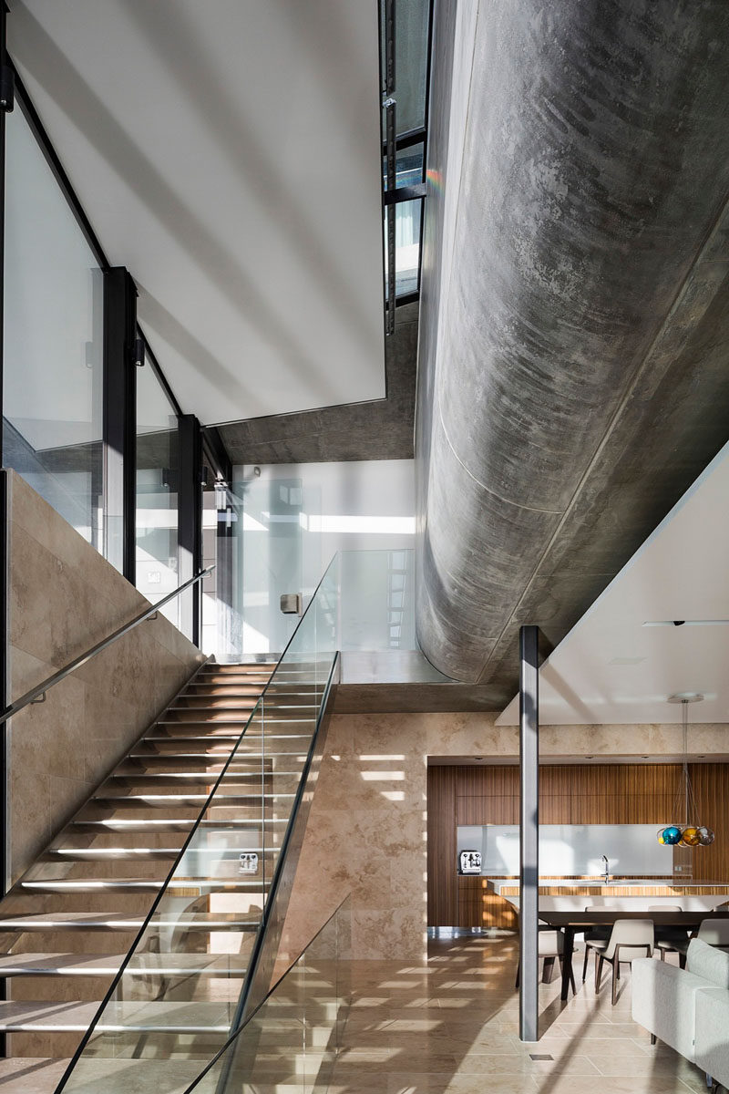 Glimpses of the curved concrete structure of this home are visible from the living area.