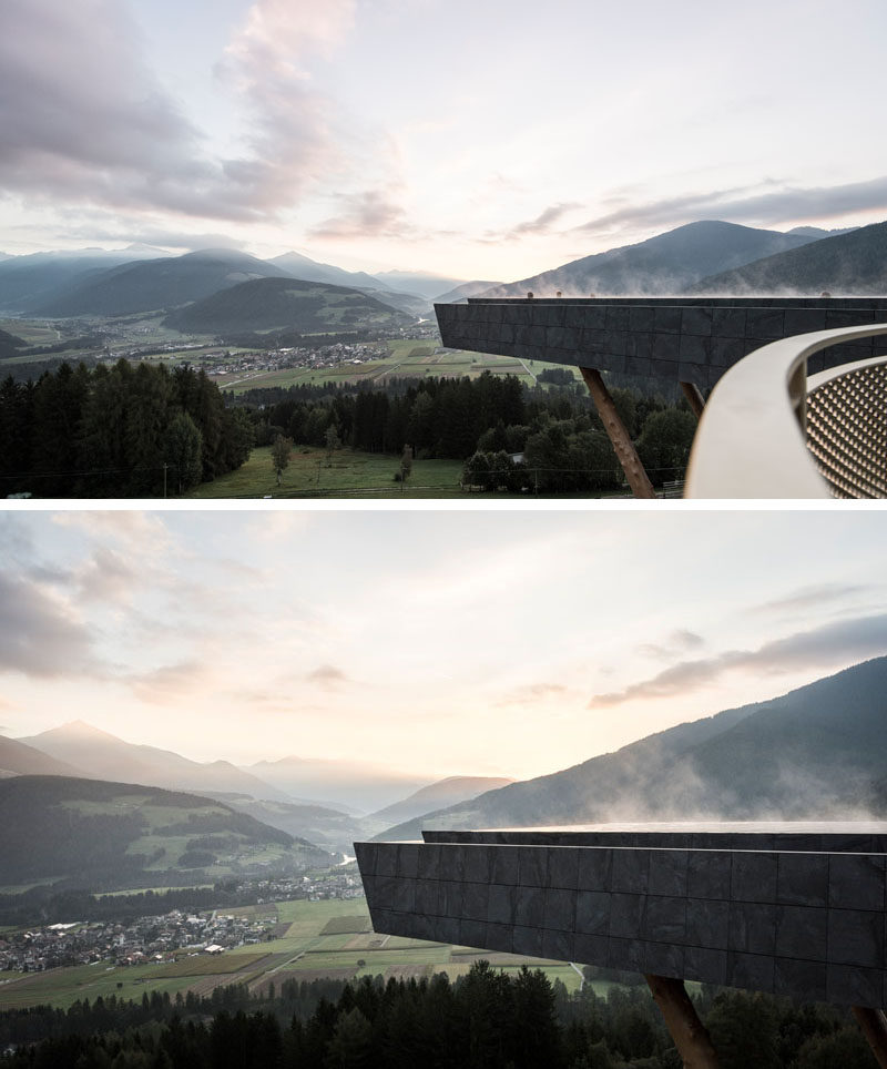 This swimming pool has been wrapped in anthracite-colored stone, almost making the pool blend into mountains that surround it.