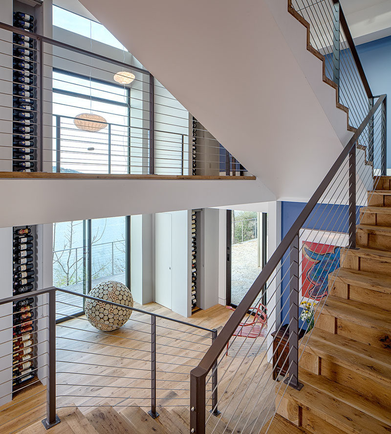 Wine Rack Ideas - Show Off Your Bottles With A Wall Mounted Display // Floor to ceiling wine racks show off the bottles and make them part of the art in the home.