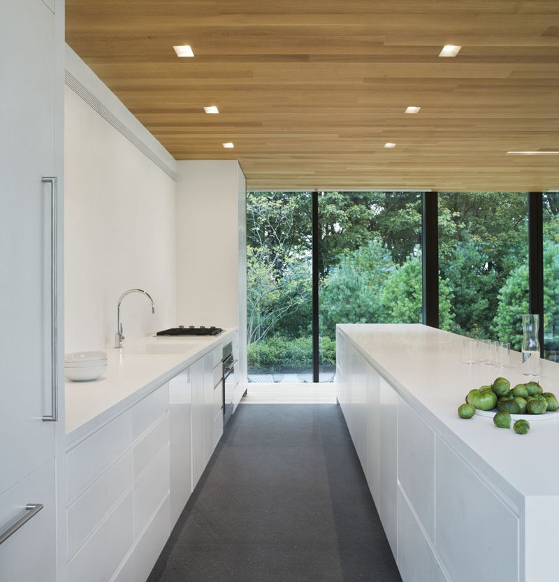 Kitchen Design Ideas - White, Modern and Minimalist Cabinets // The white cabinets without hardware give the kitchen a smooth and streamlined look.