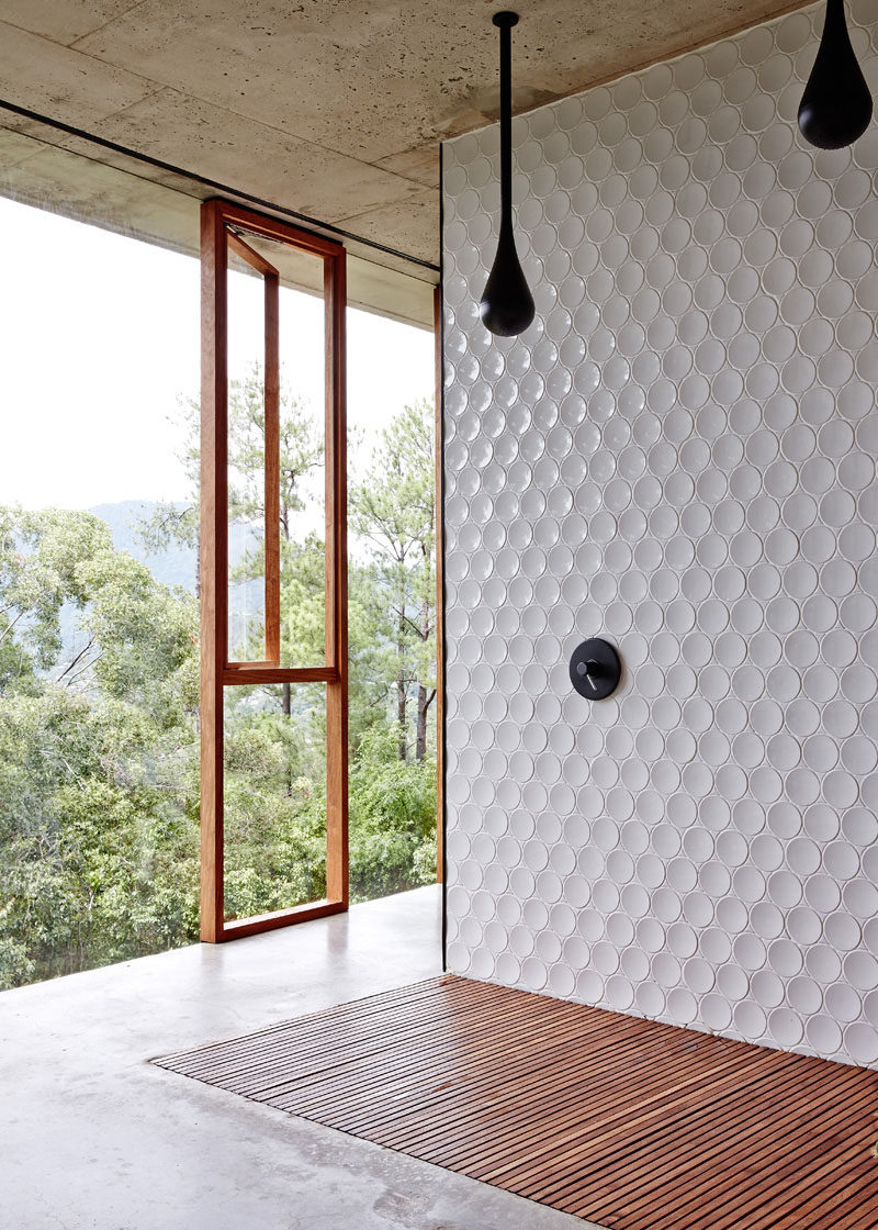 Bathroom Tile Ideas - Install 3D Tiles To Add Texture To Your Bathroom // These slightly concave circular tiles have just enough curve to them to keep them from looking flat and are a nice modern contrast to the concrete and wood used throughout the rest of the bathroom.