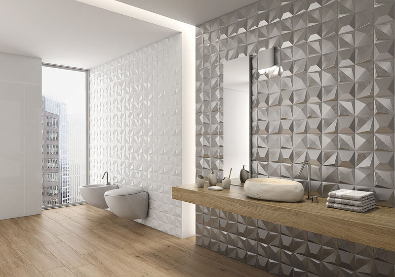 Bathroom Tile Ideas - Install 3D Tiles To Add Texture To Your Bathroom // The metallic tiles on one of these bathroom walls give the bathroom a glamorous feel while the white 3D tiles add a more subtle texture to the walls.