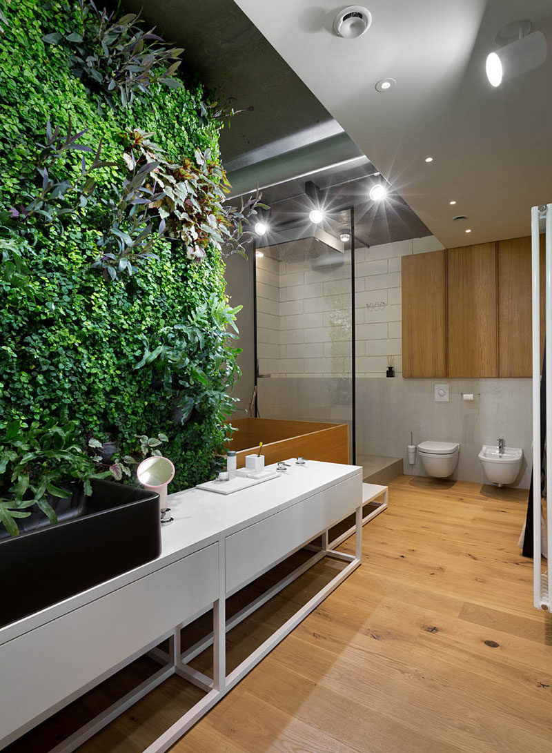 Bathroom Design Ideas - Black Shower Frames // The black frame around the shower adds a modern, industrial touch to the natural elements of wood and greenery throughout the bathroom.