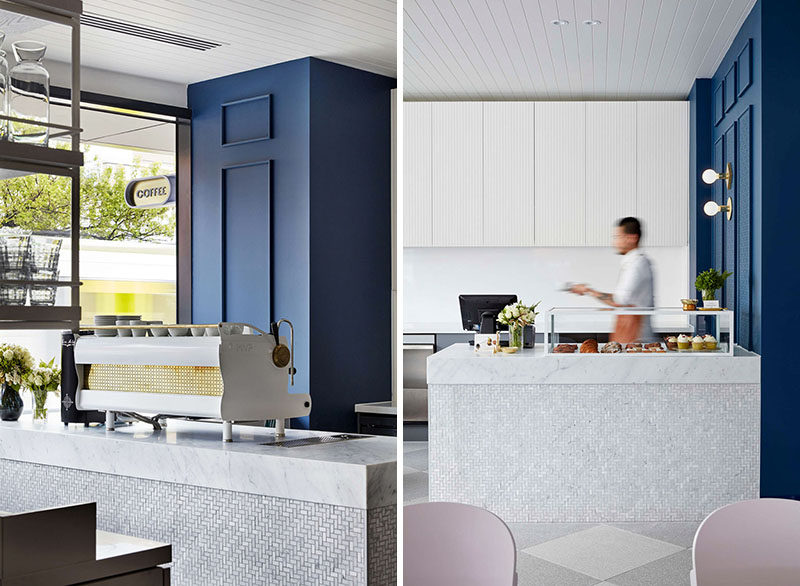 In the design of this contemporary cafe, small stone tiles cover the front of the serving area that's topped with a stone countertop and glass food display case.