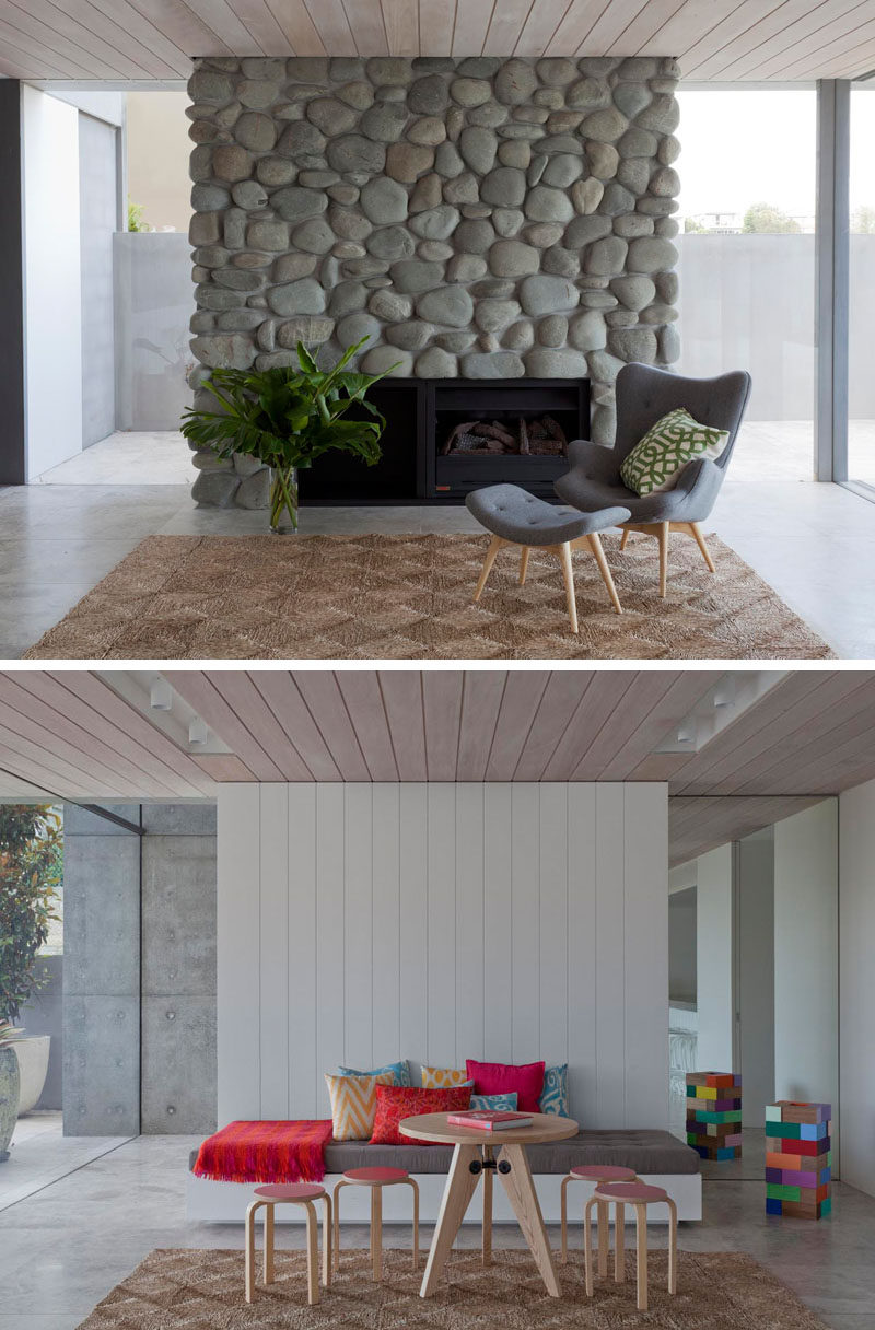 This casual living area has a fireplace surround made from river stones.