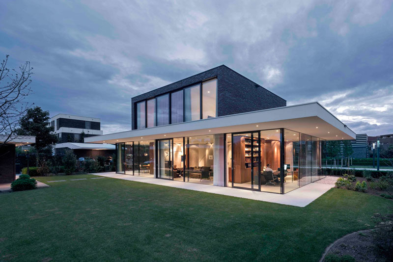 Architecture firm Powerhouse Company, have designed this dark brick and glass contemporary home for a family with two children in the Netherlands.