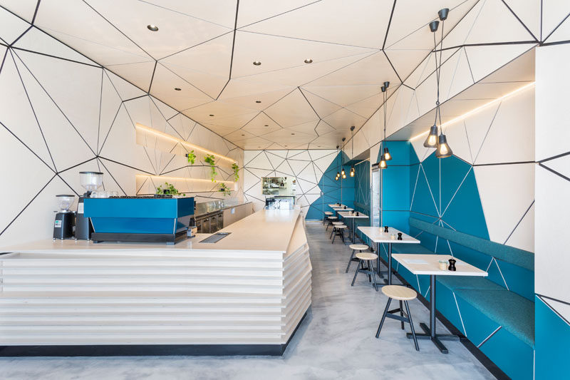 This compact contemporary cafe has a tessellated pattern that wraps from the walls around to the ceiling.