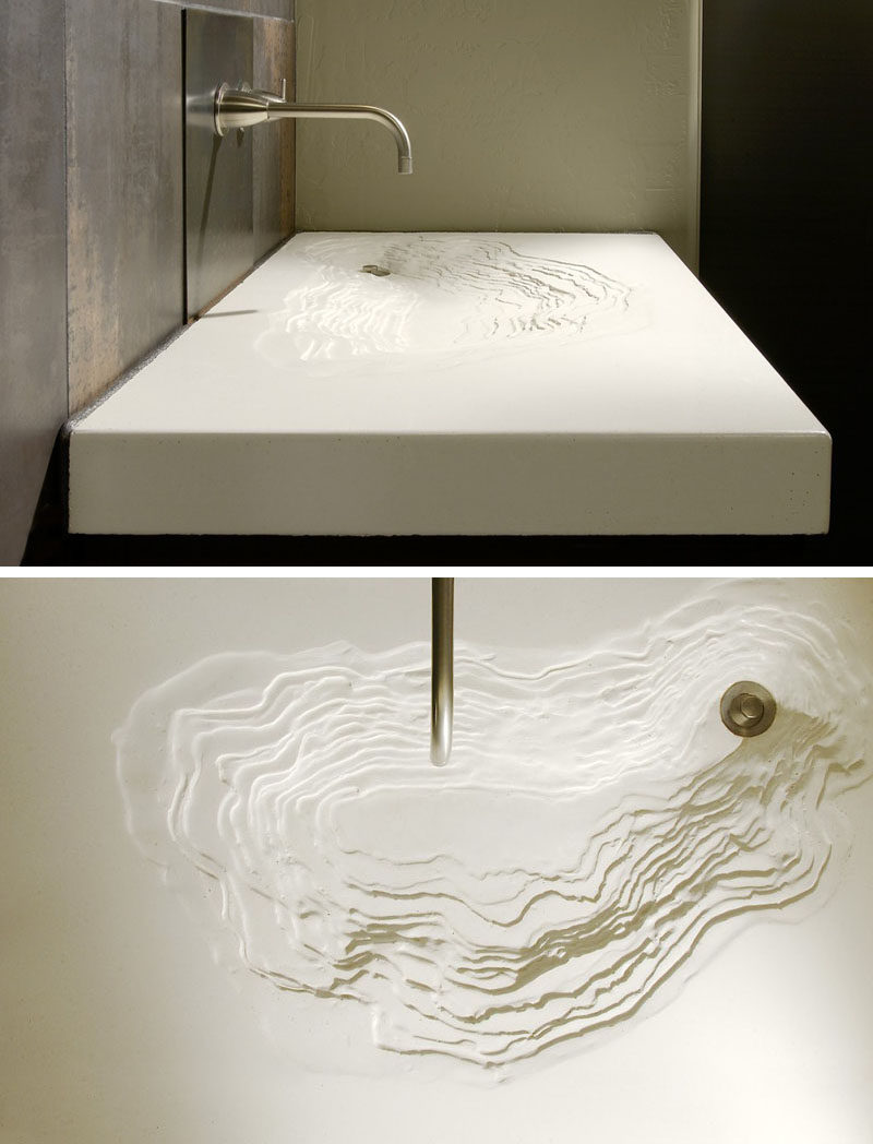 11 Creative Concrete Countertop Designs To Inspire You // This topographic sink is custom made to create a unique eroded looking structure that's made entirely from concrete.