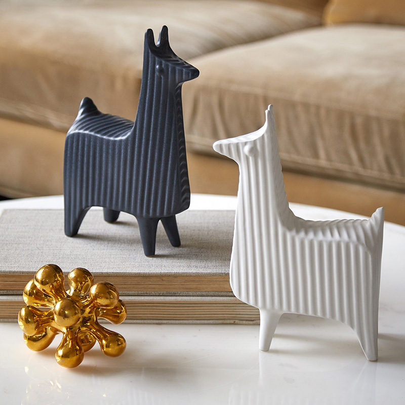 18 Decorative Animal Objects That Blur The Line Between Toys And Decor // Add a couple of llamas to your coffee table for a bit of sophisticated fun.