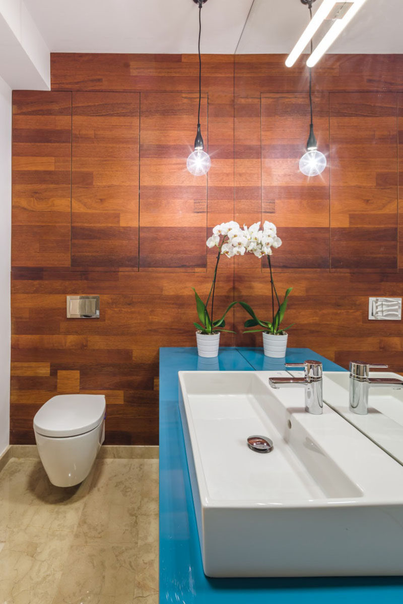 Bathroom Design Idea - Extra Large Sinks Or Trough Sinks (20 Pictures) // The bright blue countertop of this bathroom makes the clean white trough sink really stand out.