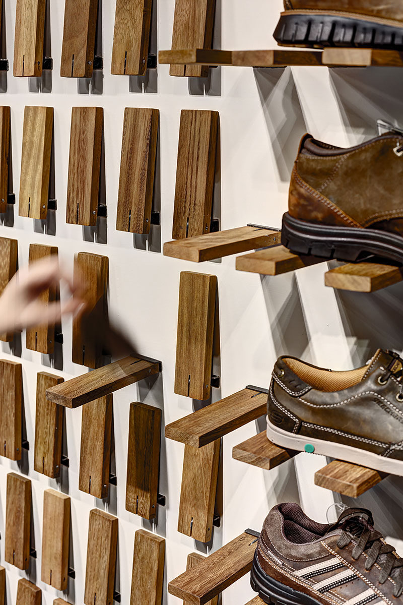 Storage Idea - Flip Down Wall Shelf // Instead of having regular shelves, the designers created a system where each individual piece of wood can be flipped down to create a shelf.