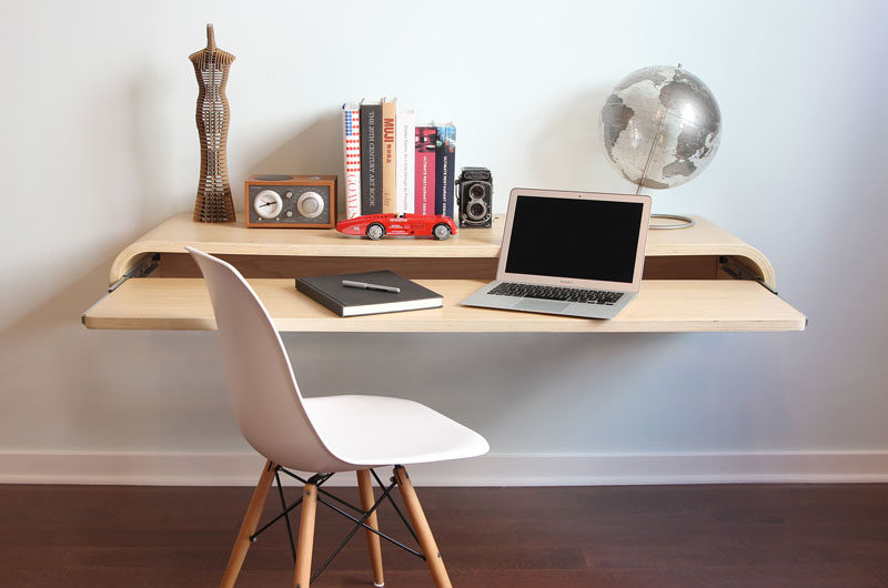 This floating wall mounted desk has a pull out shelf.