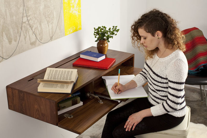 The front of this floating wall mounted desk flips down to reveal storage and a pull out desk.