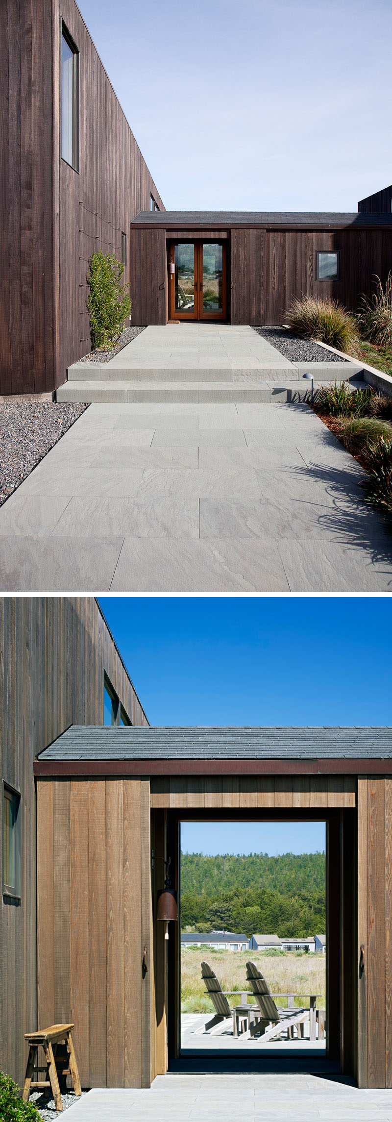 A stone path leads to front door of this contemporary wooden house.