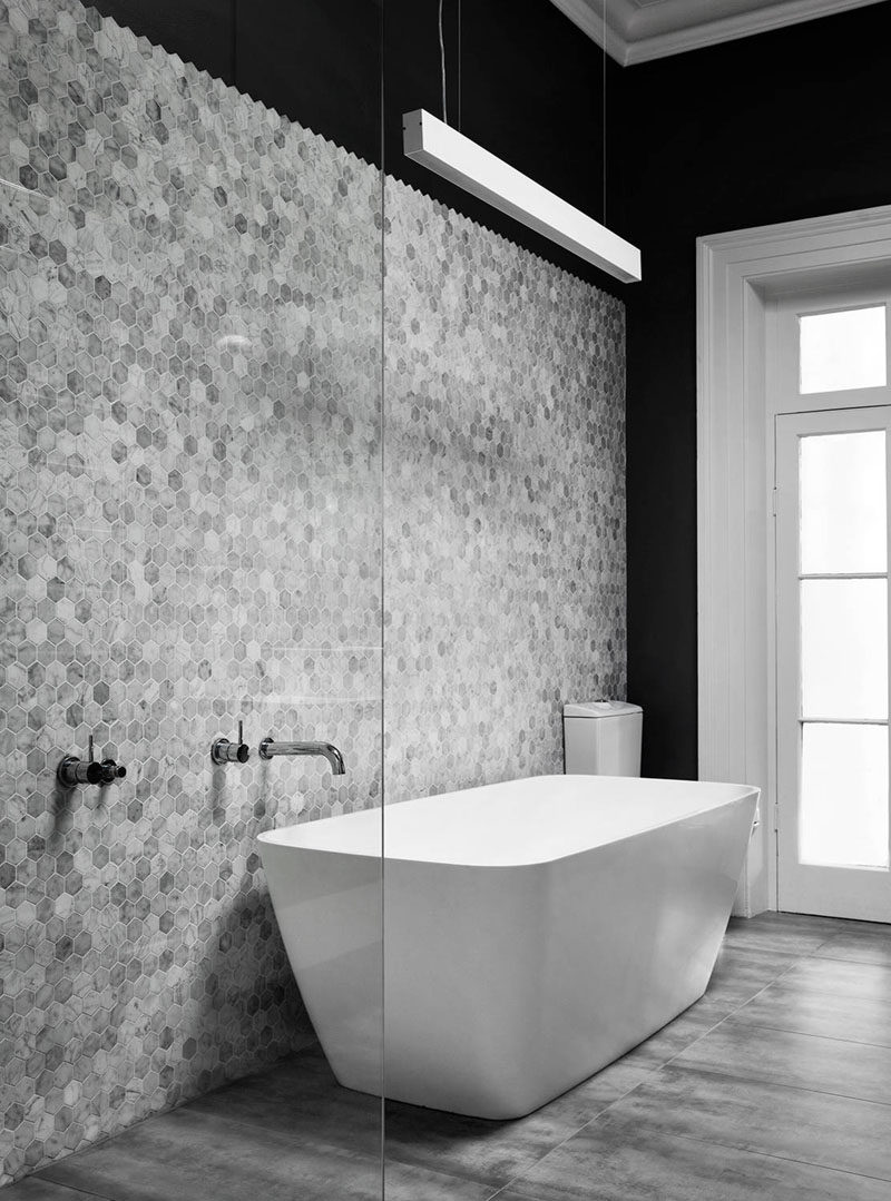 Bathroom Tile Ideas - Grey Hexagon Tiles // The small grey hexagon tiles on the wall of this bathroom don't reach all the way to the top of the wall, creating a zigzag pattern where the tiles stop.