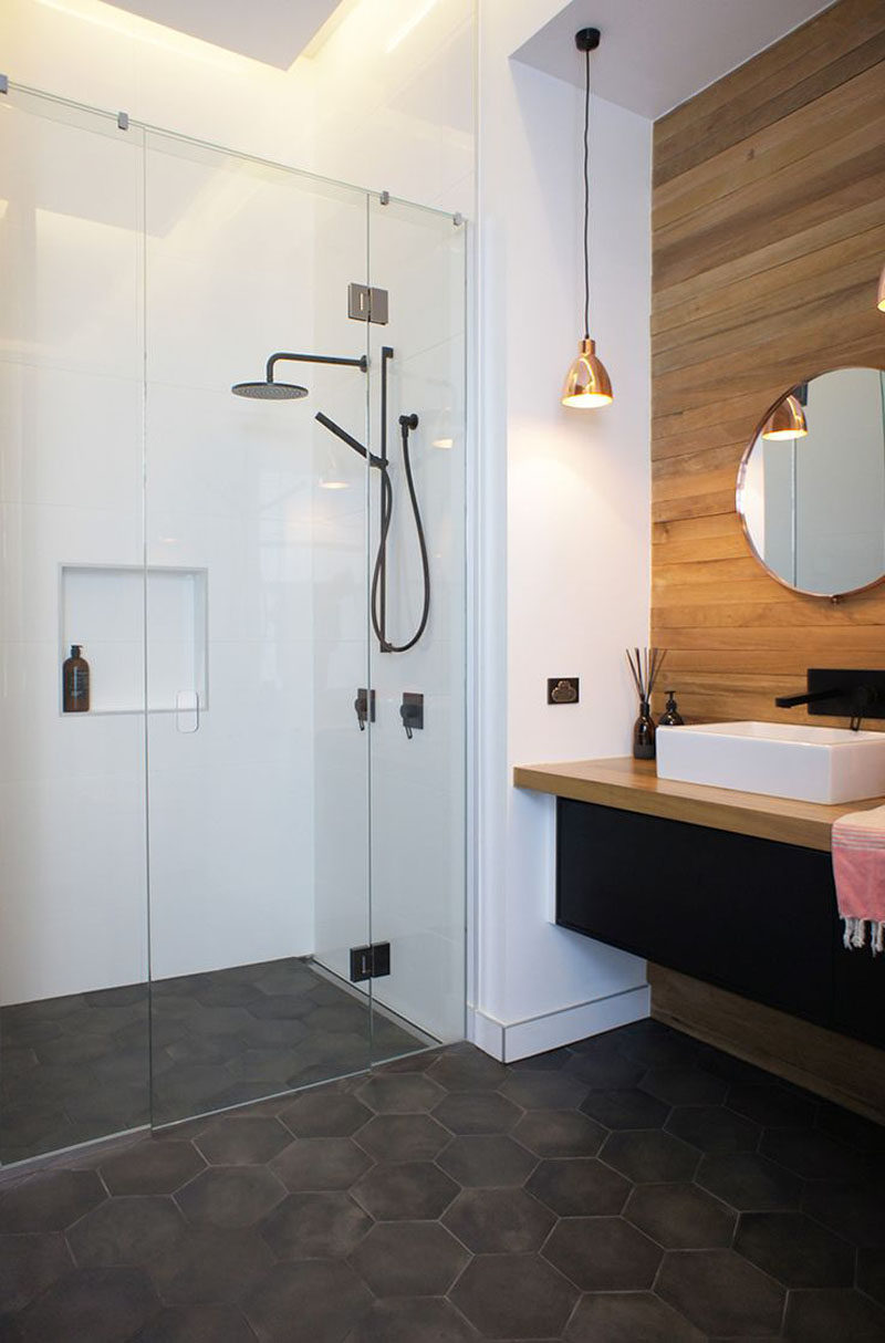 Bathroom Tile Ideas - Grey Hexagon Tiles // Dark grey hexagon tiles on this bathroom floor partnered with the wood paneled feature wall make the space feel modern and inviting.