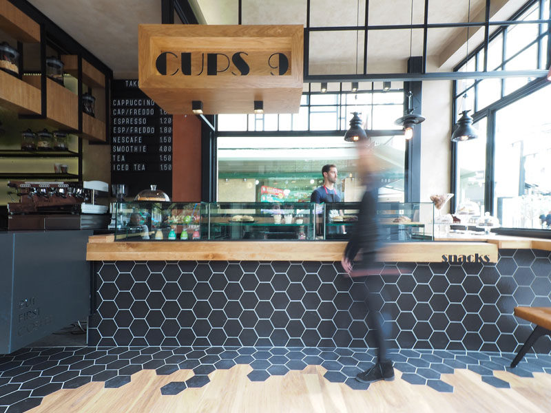 Hexagon Tiles Transition Into Wood Flooring Inside This Cafe In Greece