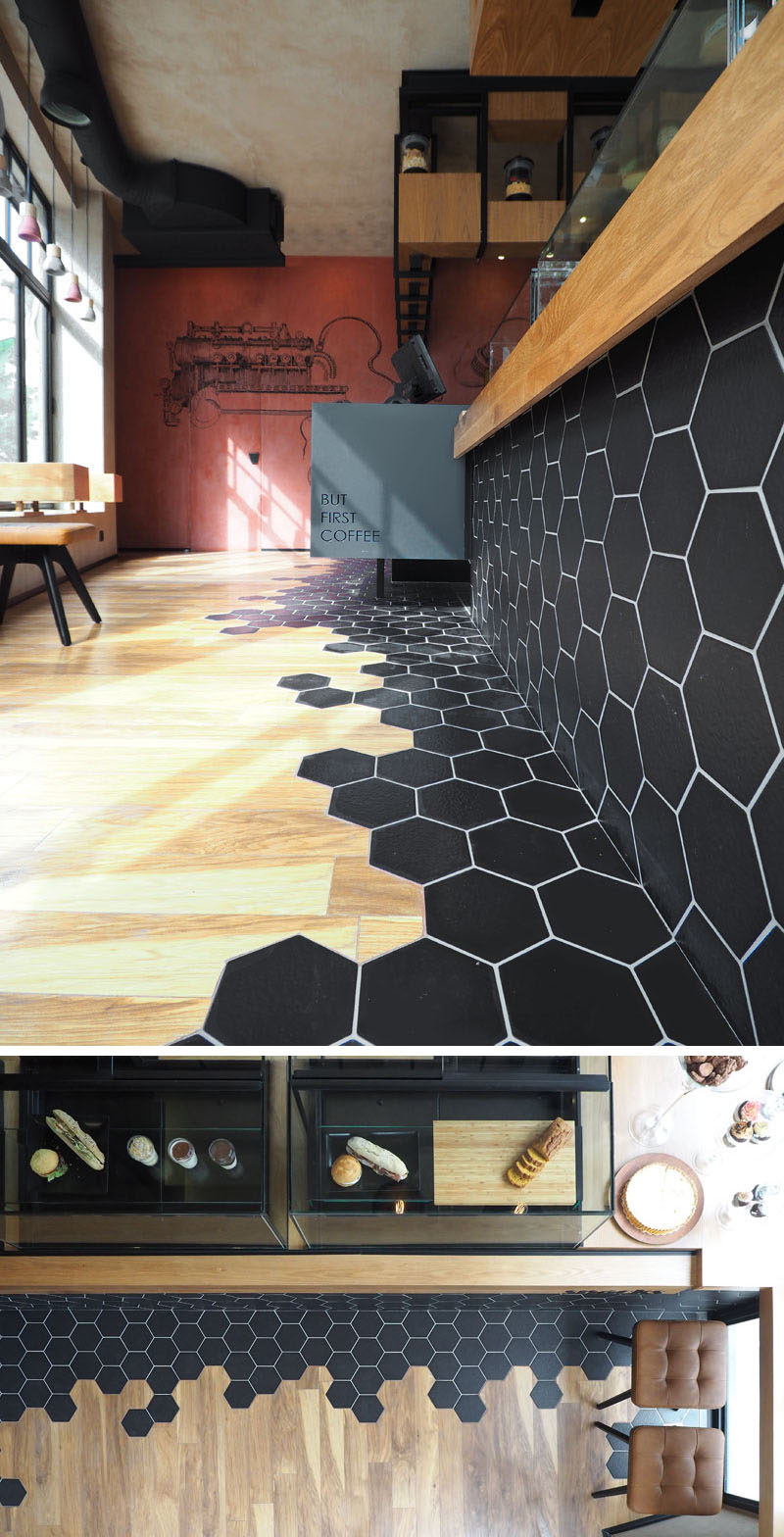 Black hexagon tiles and wood laminate flooring are a design element in this modern cafe.