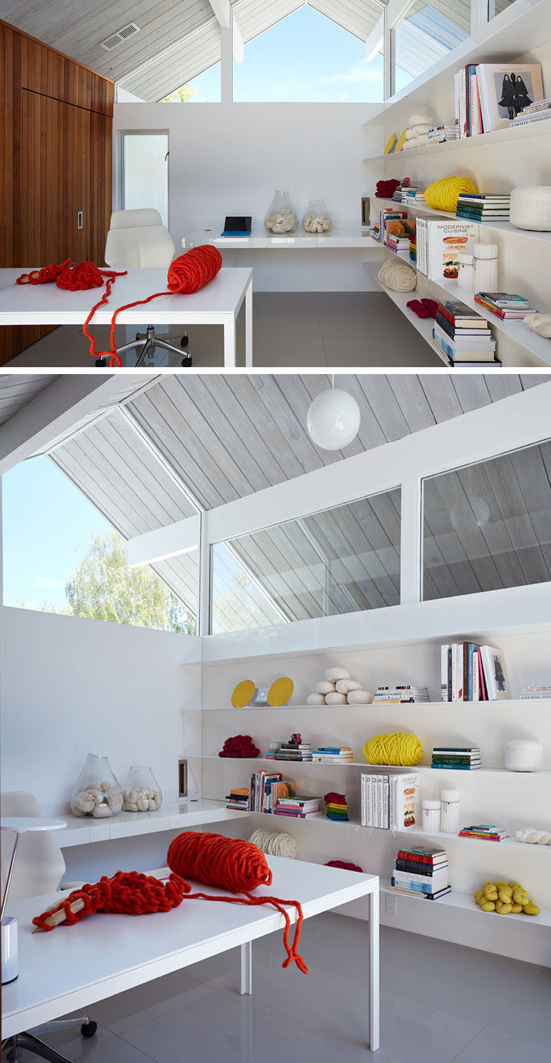 Inside this home office, there's plenty of light from the windows and floating shelves provide plenty of storage.