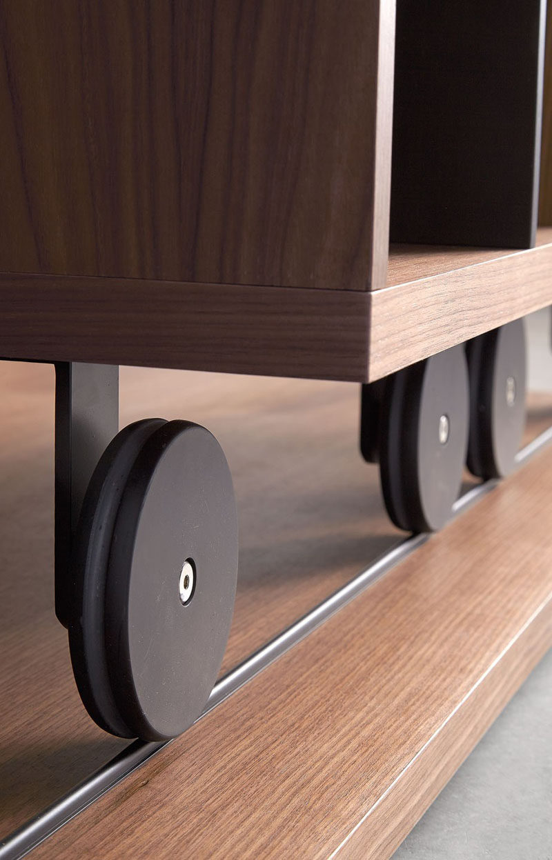 Interior Design Details - Industrial Close Ups // The wheels on the bottoms of this sliding bookcase add an industrial touch to the modern piece of furniture.