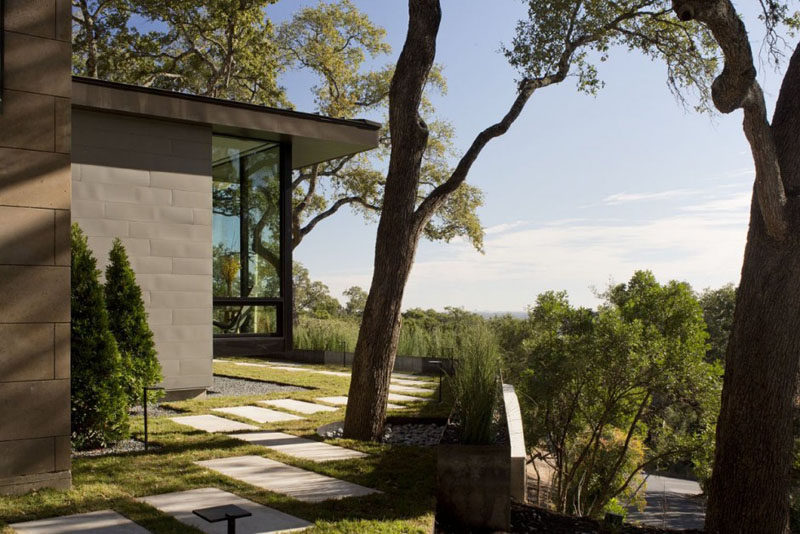 A stone path takes you around the yard of this home.