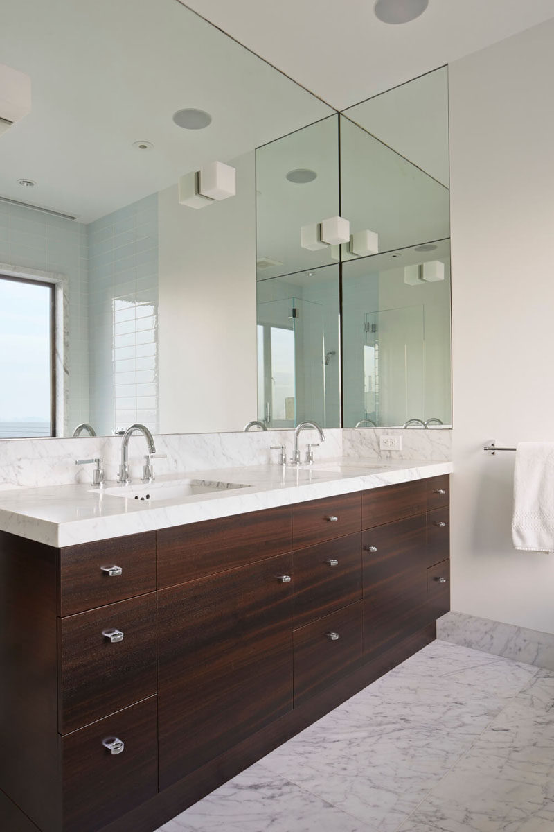 Bathroom Mirror Ideas - Fill The Wall // The large mirror in this bathroom wraps around just a little bit of the wall next to it to line up with the edge of the vanity.