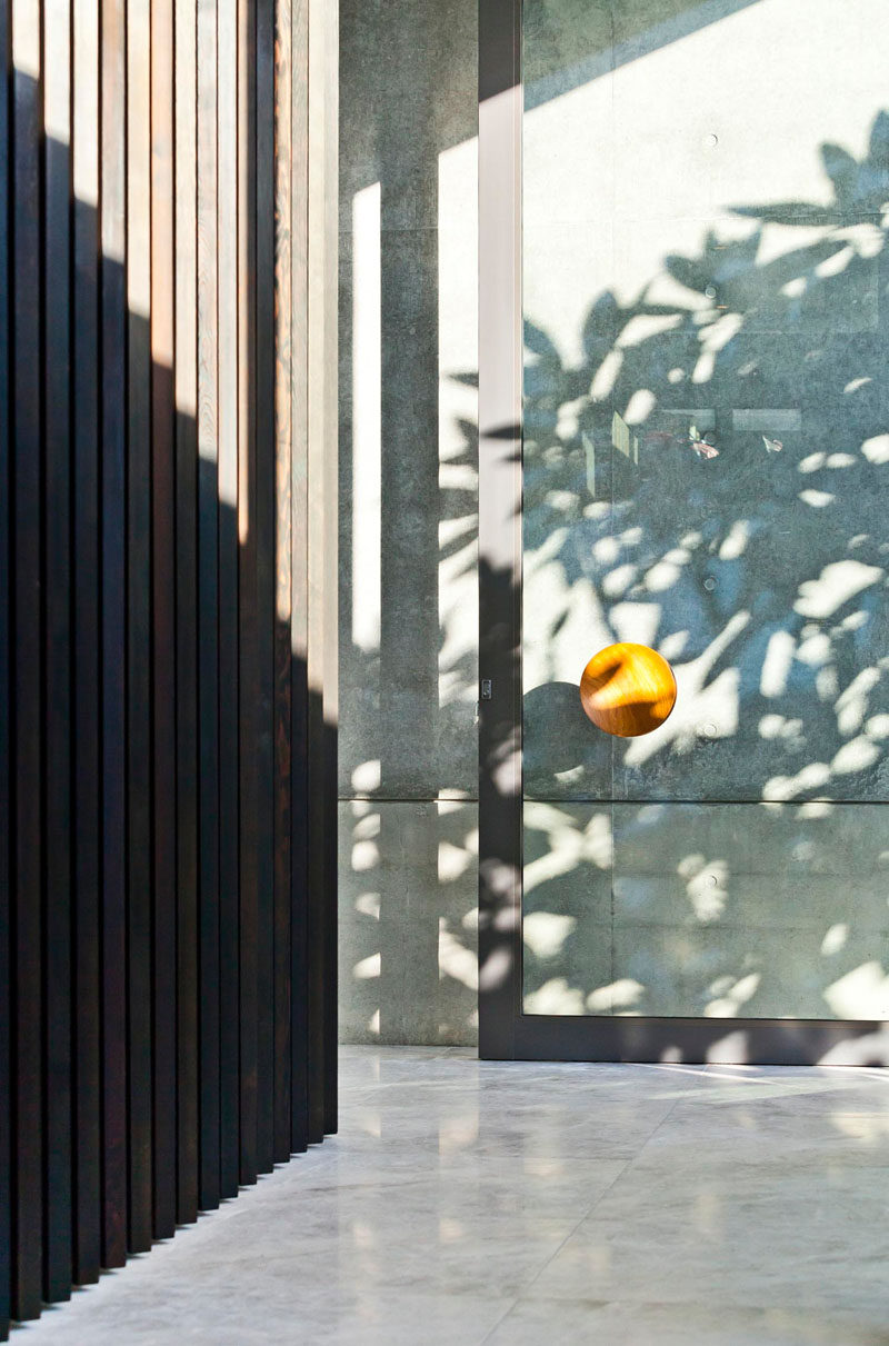 A large glass front door with oversized handle welcomes you to this home.