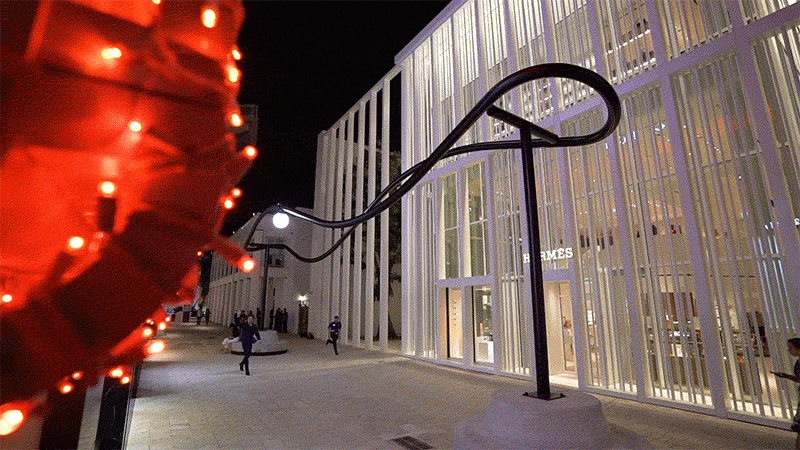 This sculptural light installation in Miami is like a roller coaster for a single light.